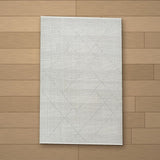Ani rug laid flat on a wooden floor
