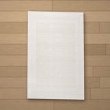 Kaunos rug laid flat on a wooden floor