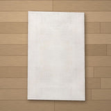 Priene rug laid flat on a wooden floor