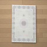 Zeugma rug laid flat on a wooden floor